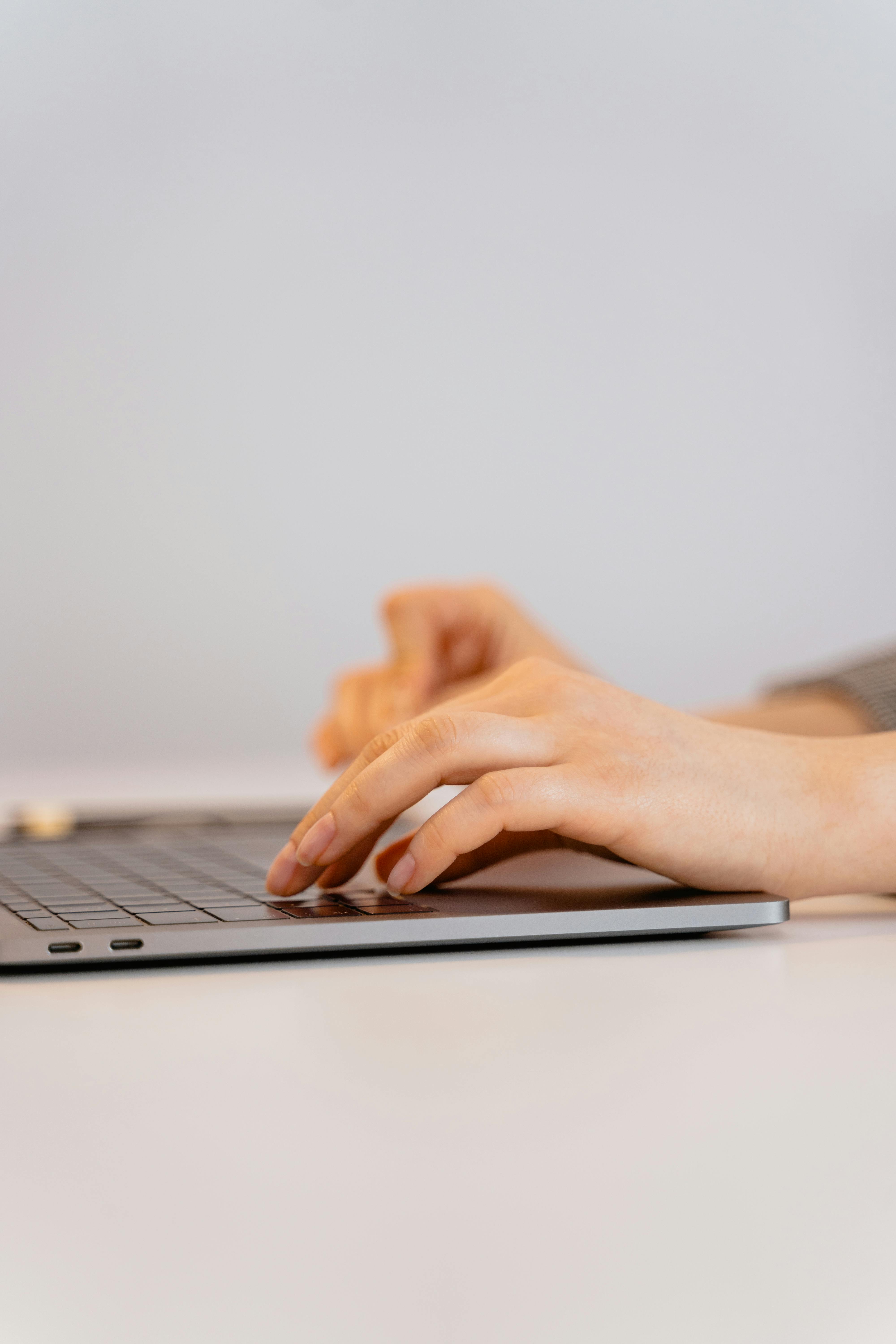A person typing on a laptop